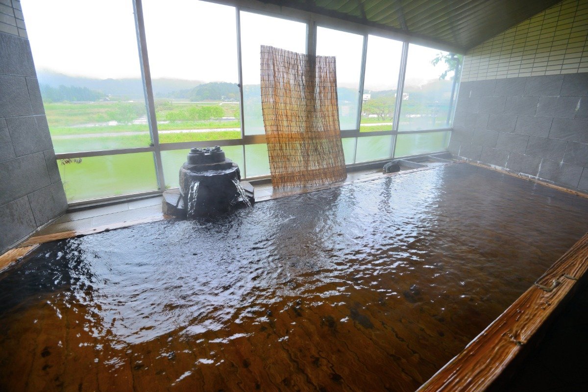 大浴場の総ひのき風呂（写真は男湯）。窓からはのどかな田園風景を見渡せます。