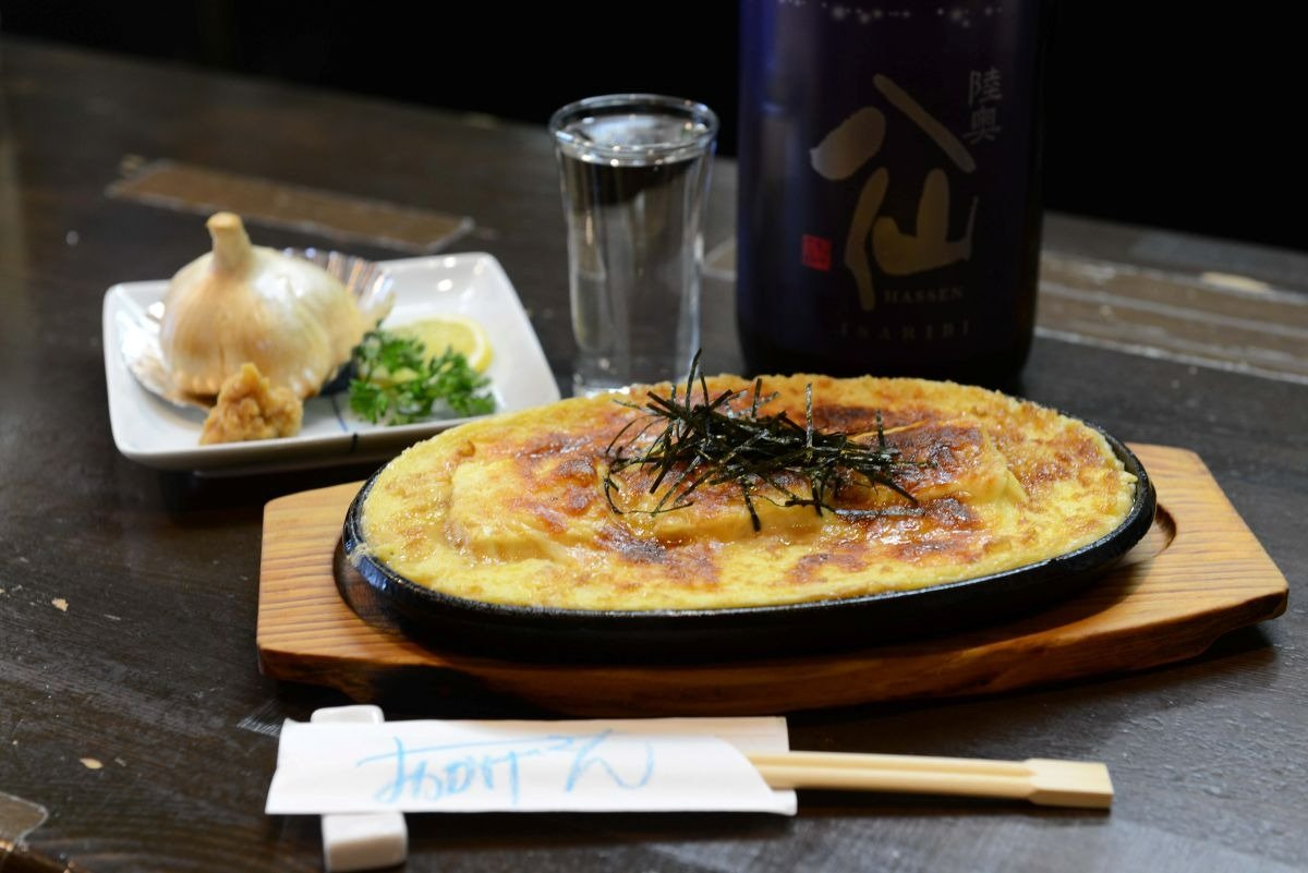 「田子（たっこ）産ニンニク丸ごと揚げ」800円、「トロトロとうふステーキ」900円は「おかげさん」のオリジナル料理