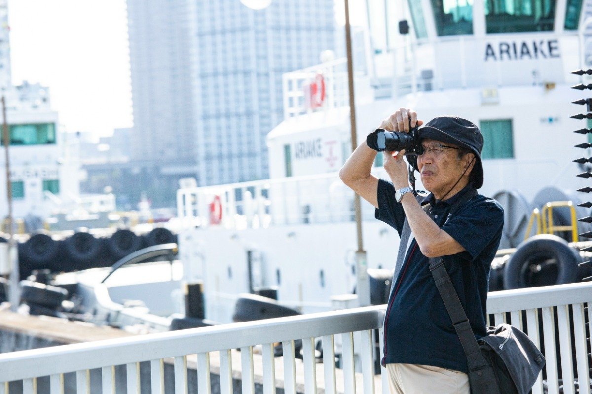 芝浦南ふ頭公園でカメラを構える岡戸さん